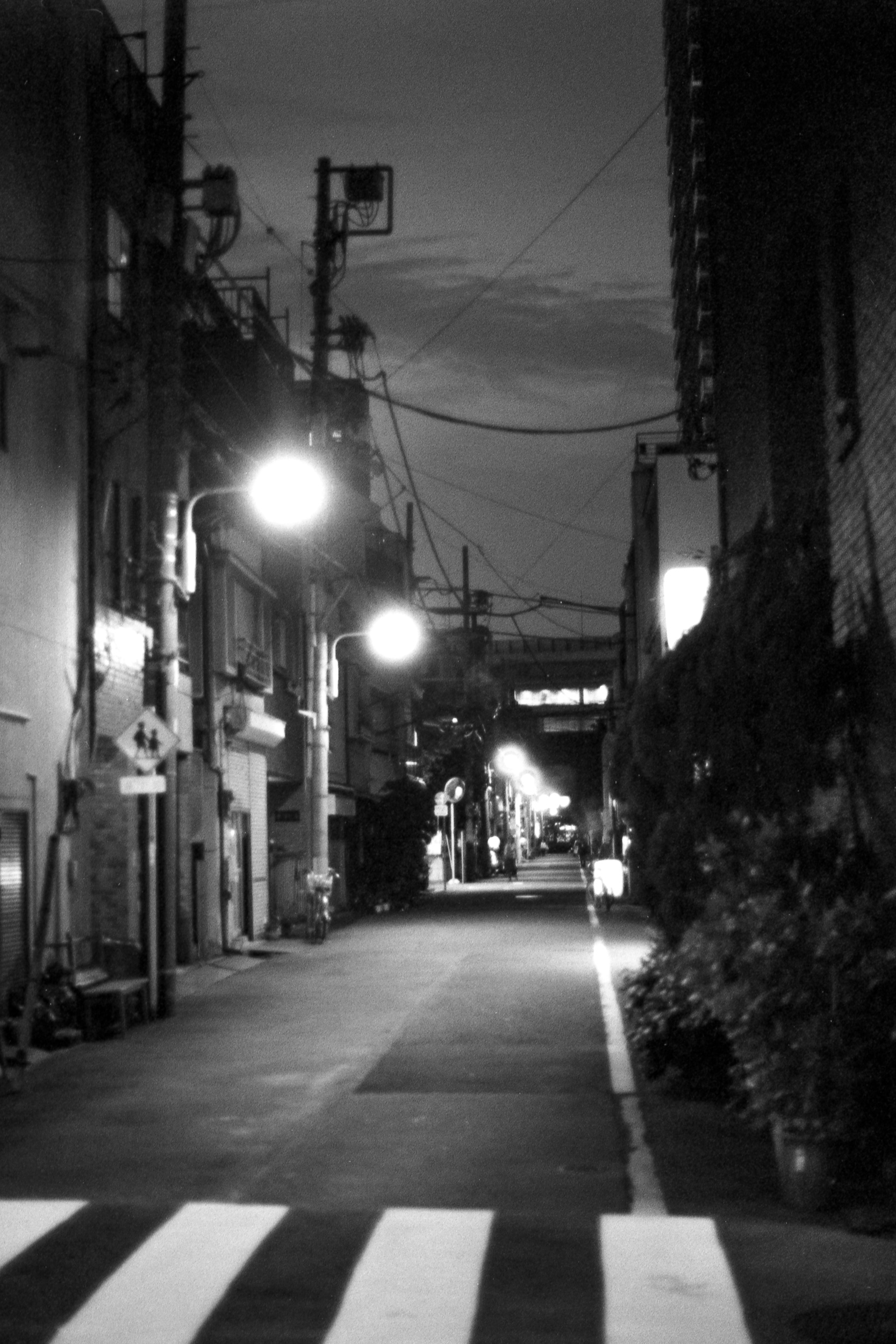 empty japanese alley with bright street lights in asakusa, 35mm black and white film