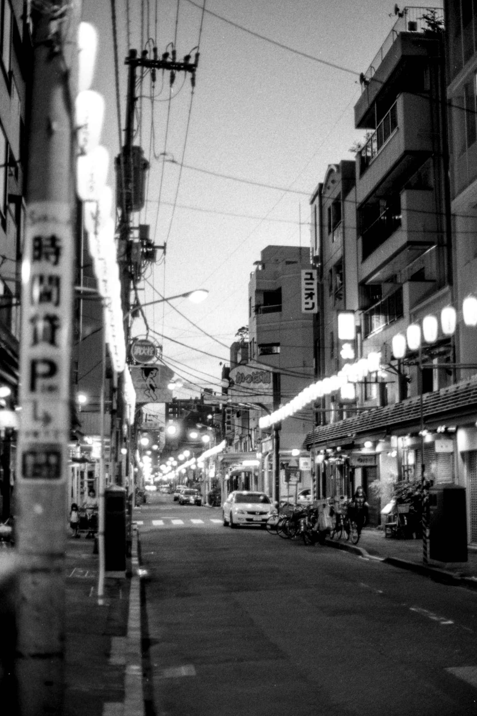 empty japanese street at night with rows of lantern lights, i8n asakusa, 35mm black and white film