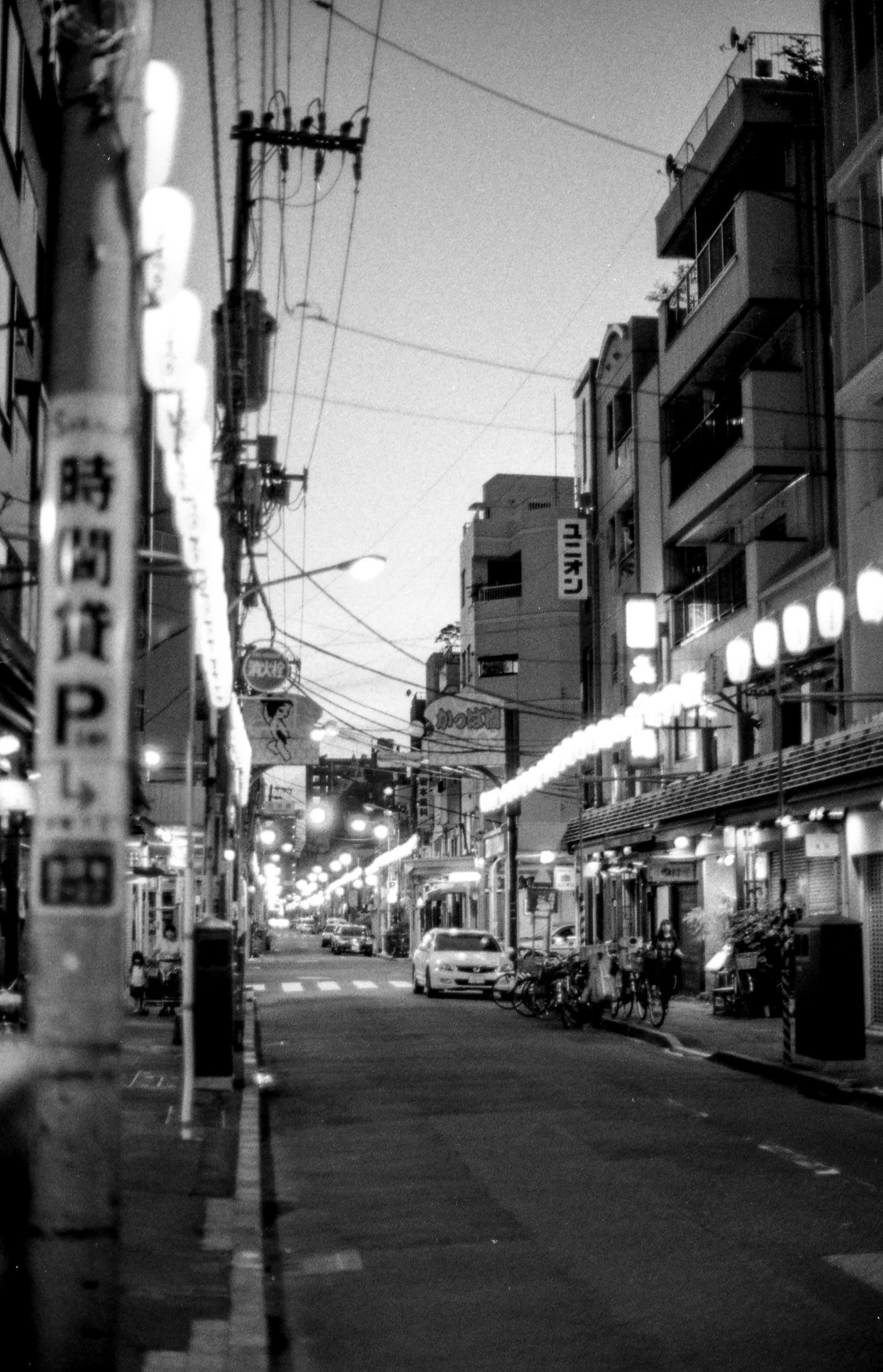 lantern lit street in asakusa japan at night, 35mm black and white film