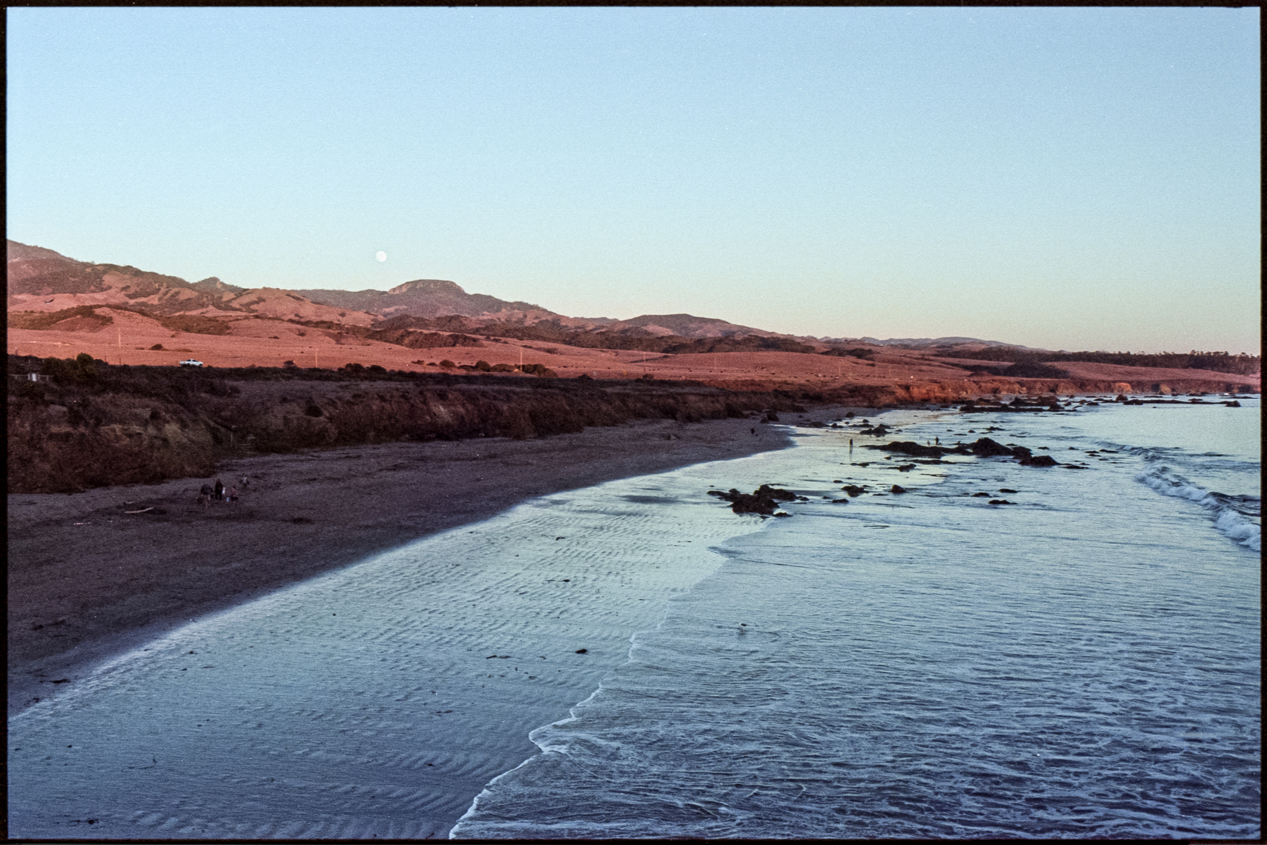 california beach and distant orange hills near san simeon at golden hour, 35mm film