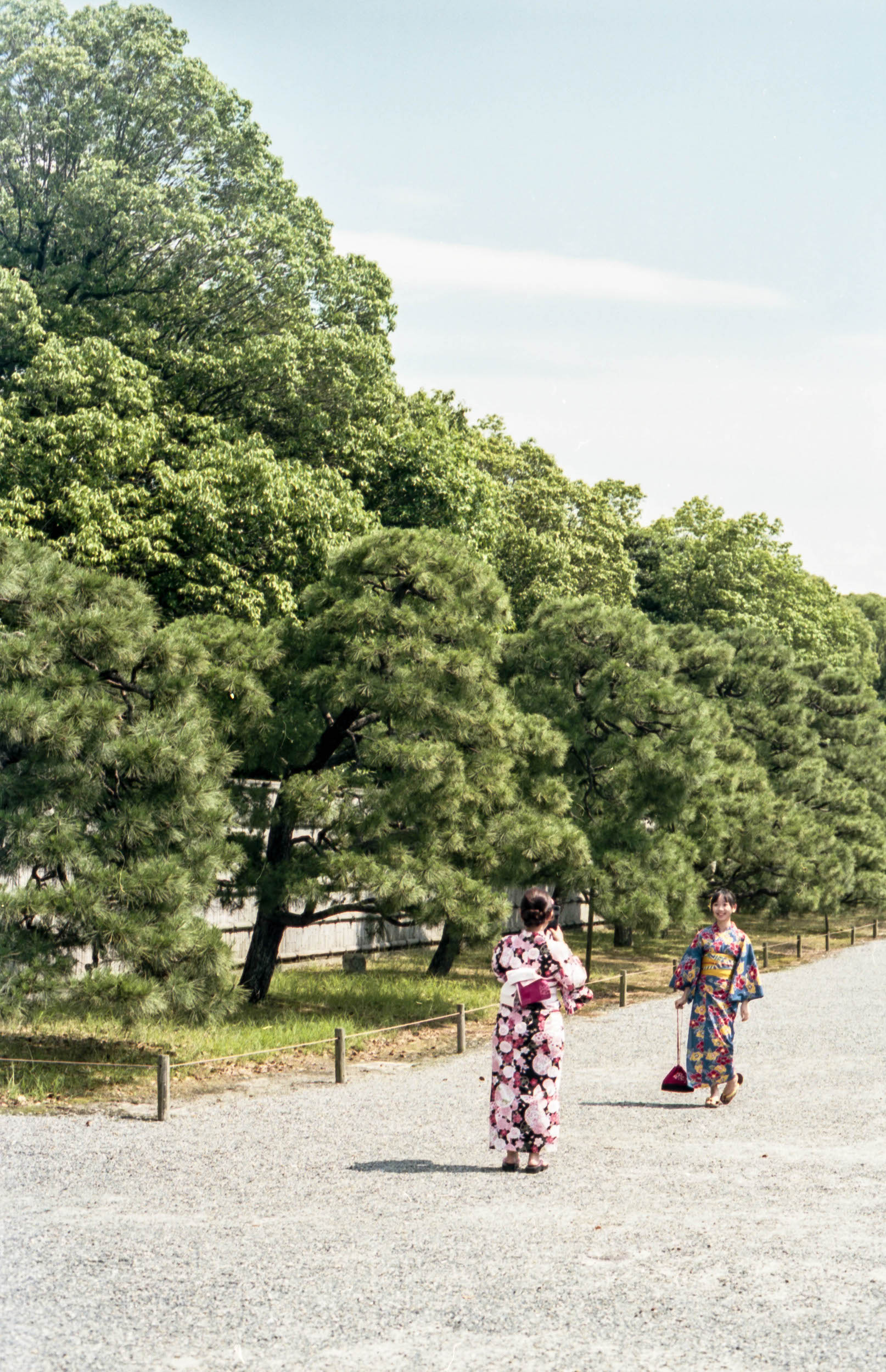 two women in traditional japanese kimono taking photographs of each other, 35mm film