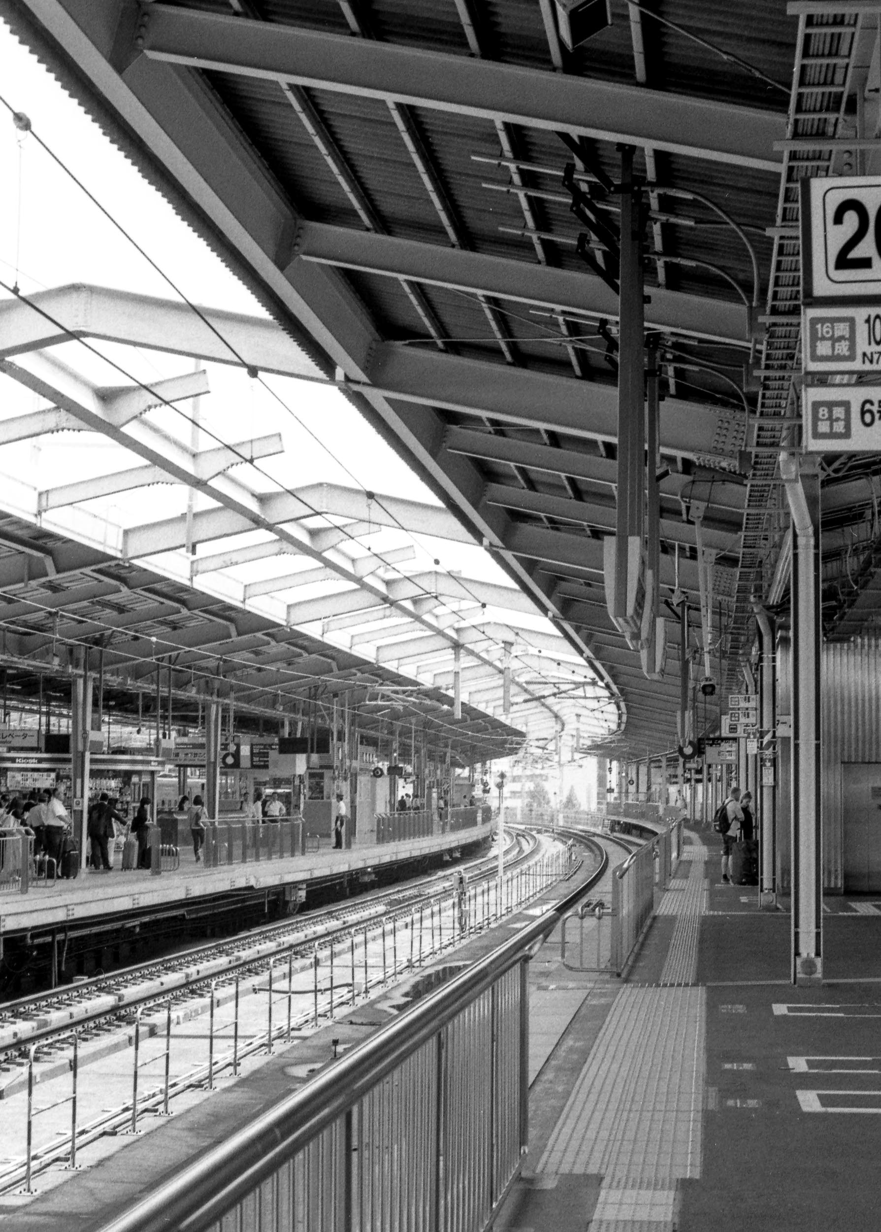 angled roof above train tracks at japanese station, 35mm black and white film