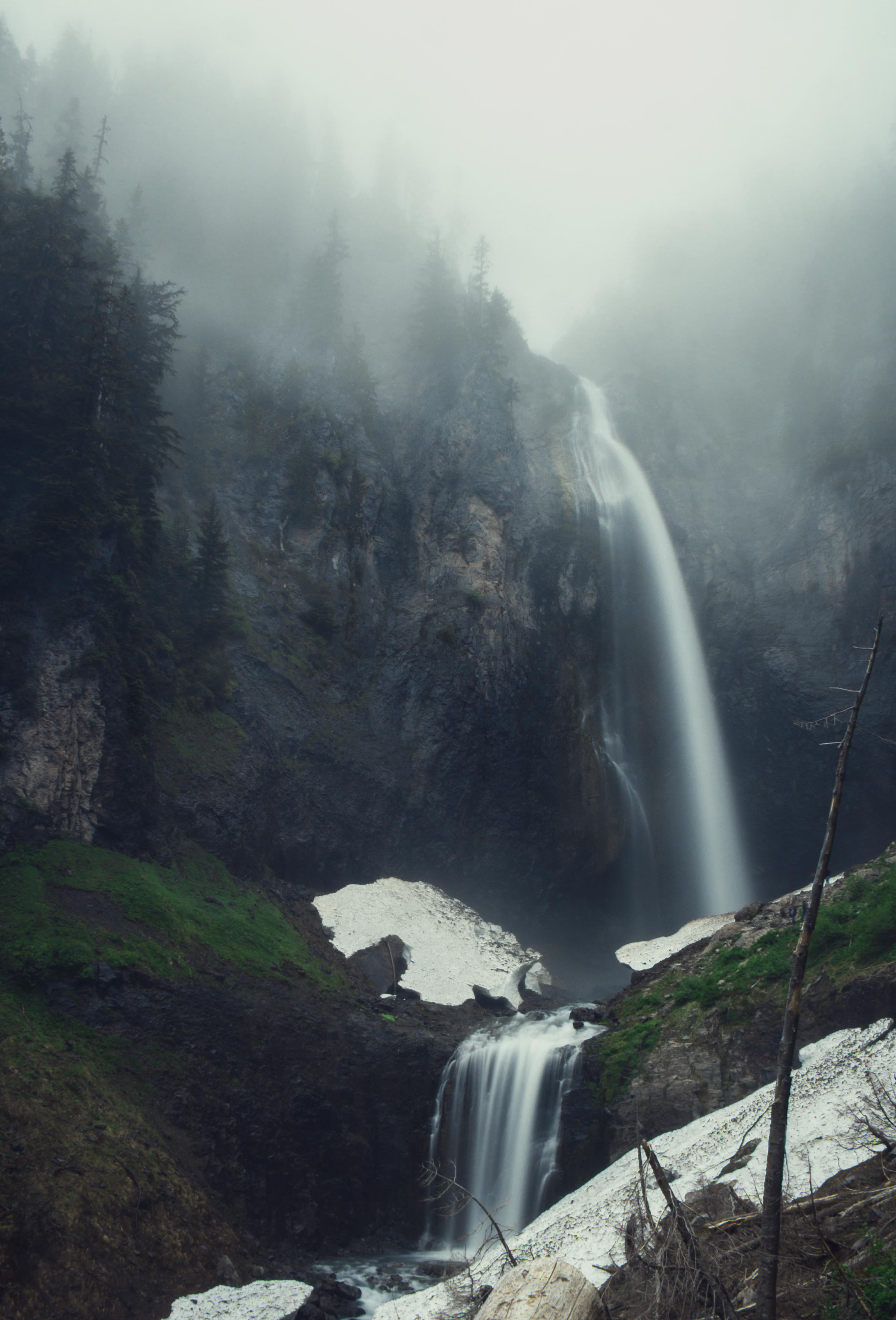 comet falls waterfall at mount rainier national park, forest foggy day